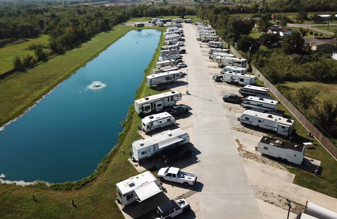 Aerial view of The Bend RV Park with pond and green surroundings