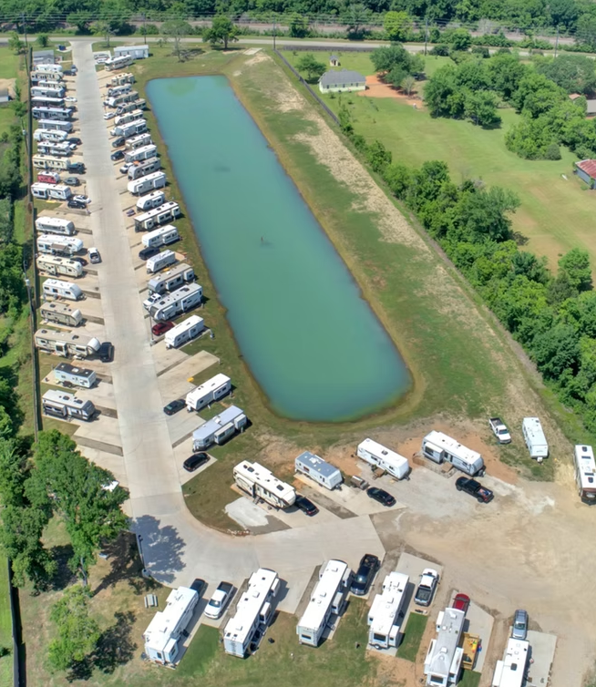 Aerial overview of RV rows alongside the park pond
