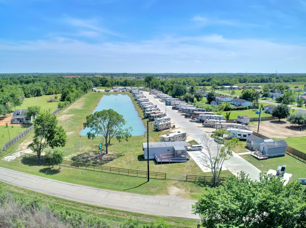 Aerial view of pond-side RV sites with fountain