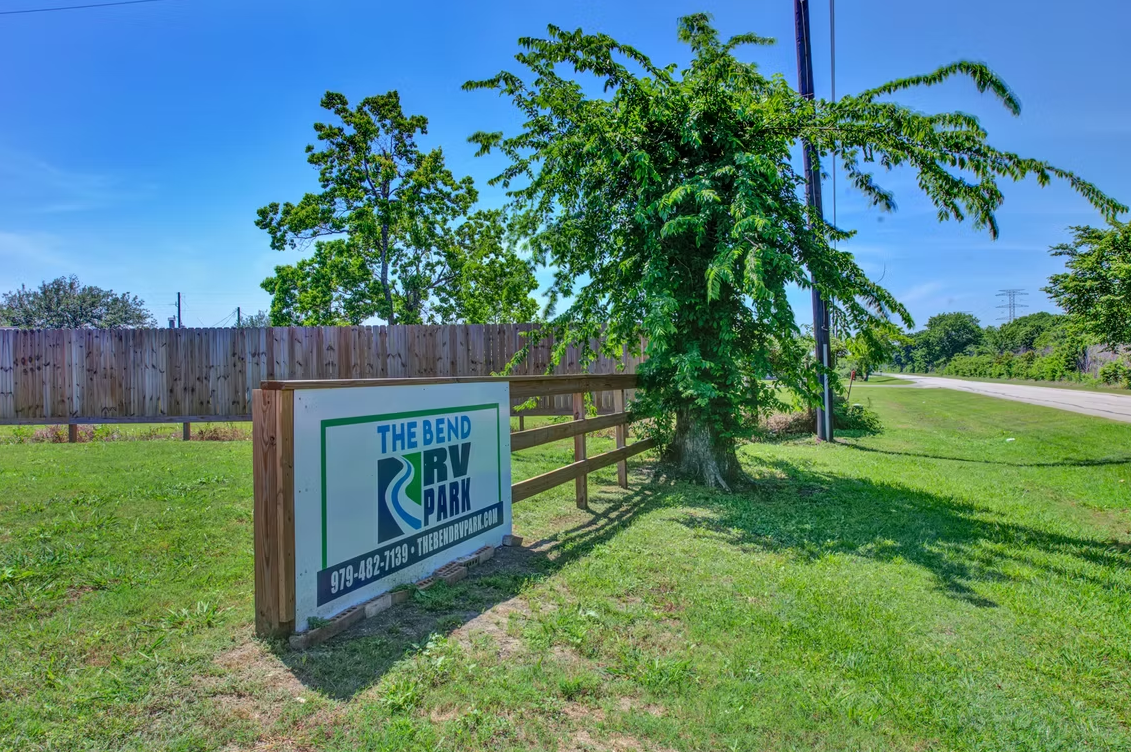 The Bend RV Park entrance sign along the road