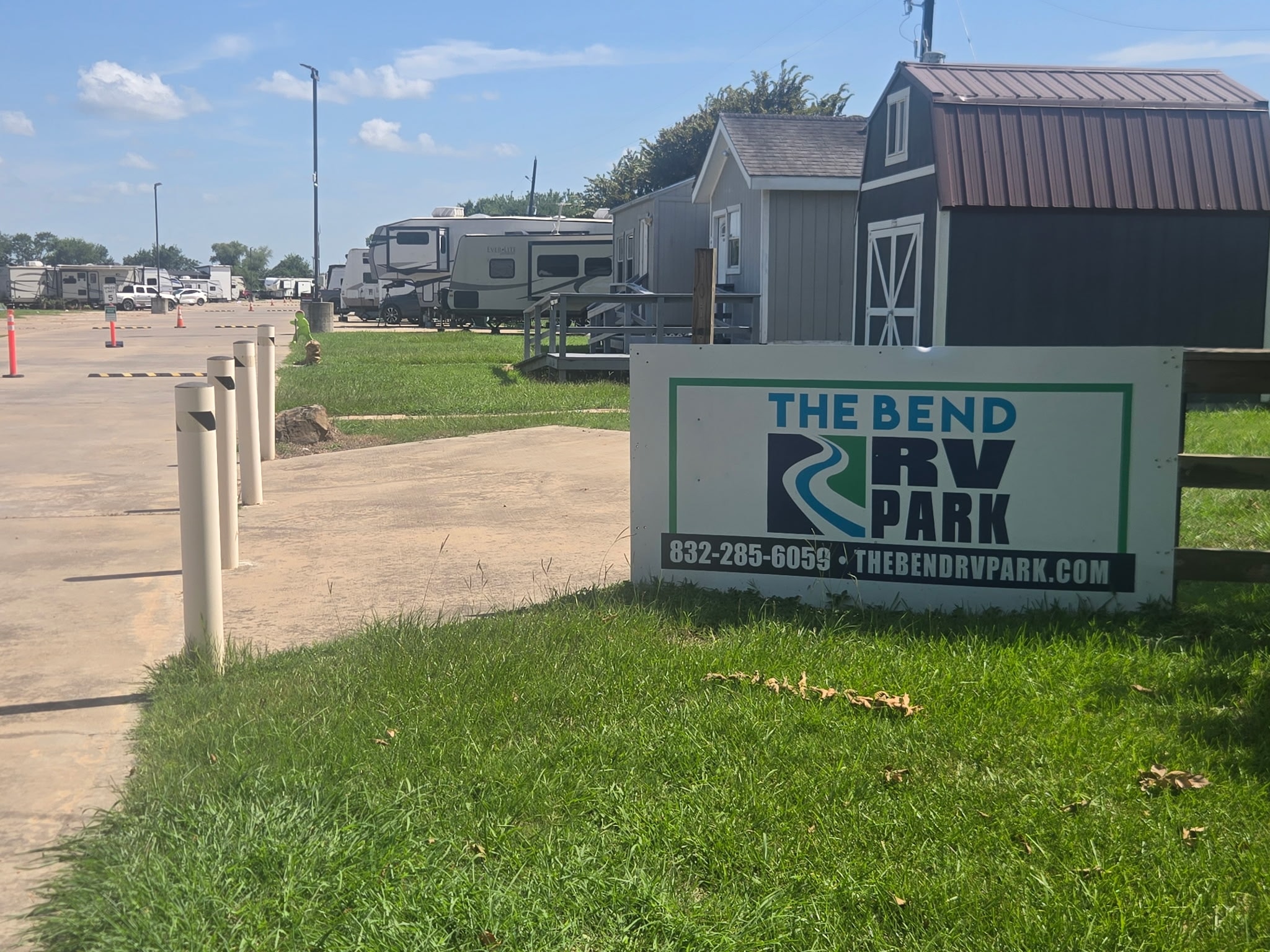 The Bend RV Park sign with park grounds and shed in background
