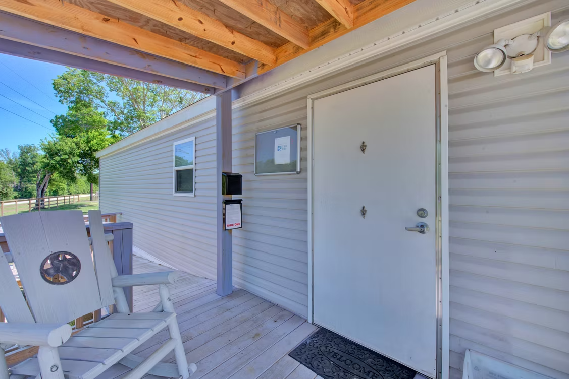 Office covered porch entrance with flower pots