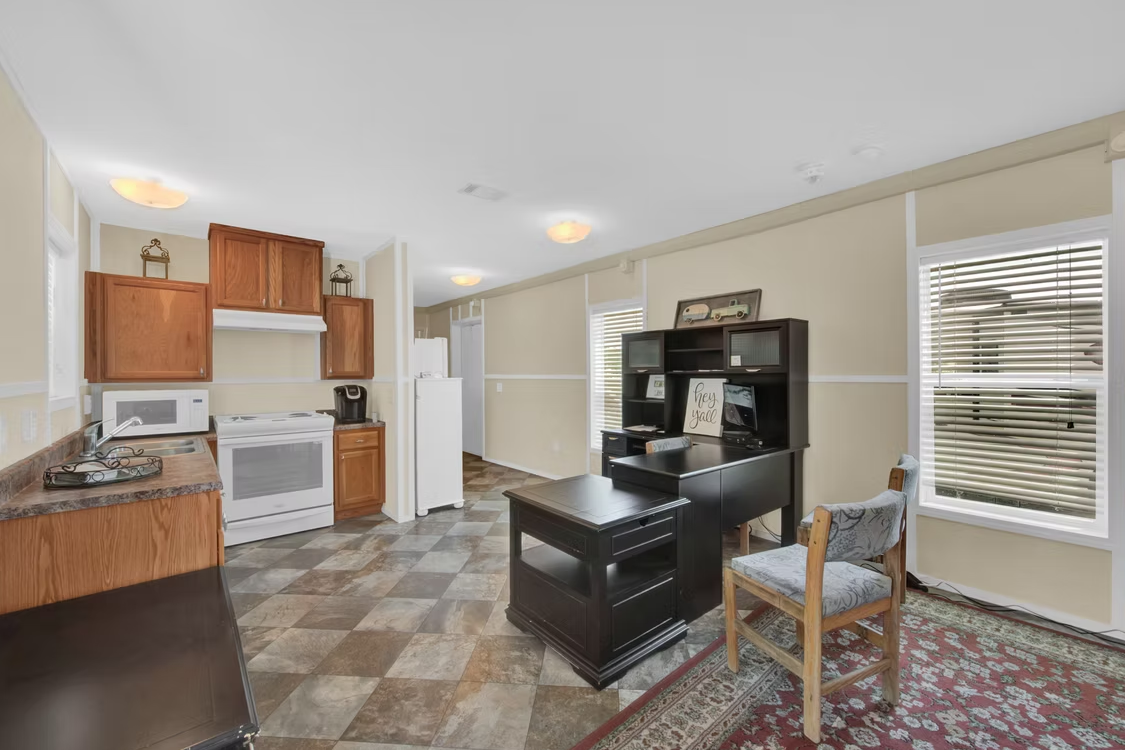 Office interior with kitchen and desk area
