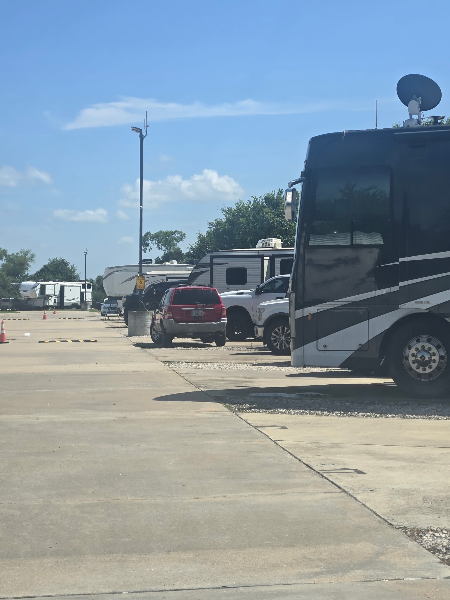 Paved road through The Bend RV Park with RVs parked on both sides