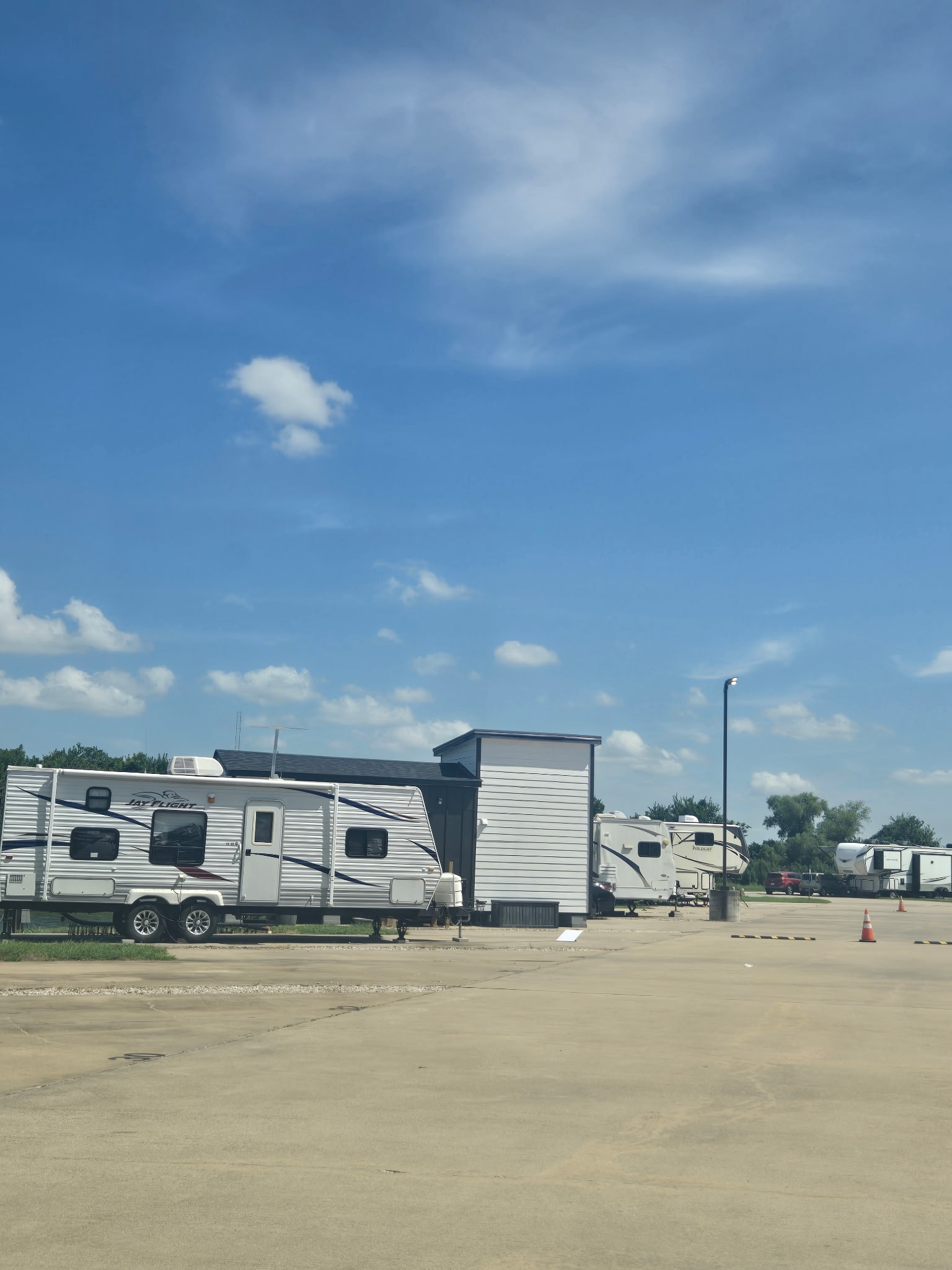 Paved road with Jay Flight trailer and park office building