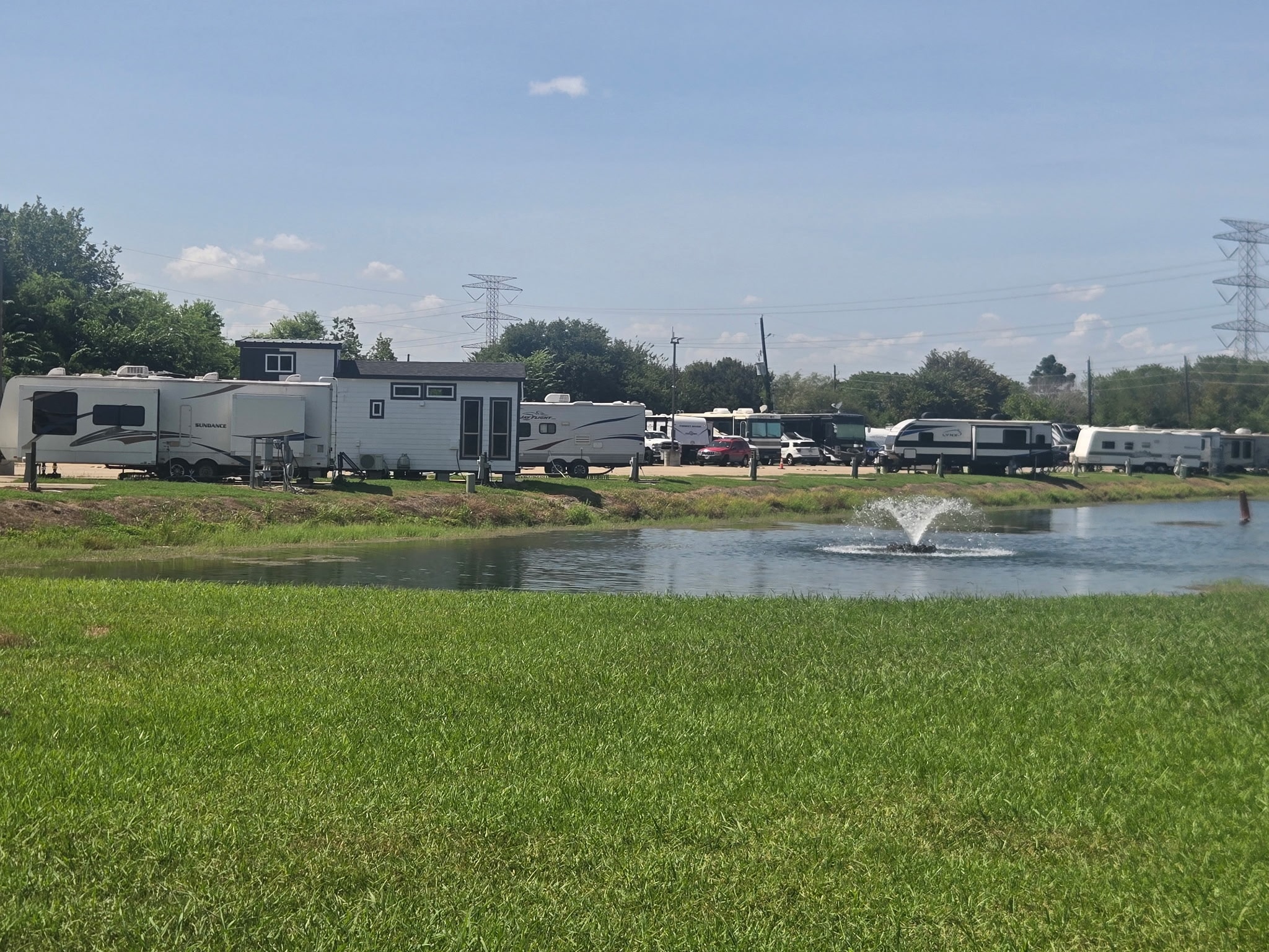 View of RVs parked along the pond with fountain