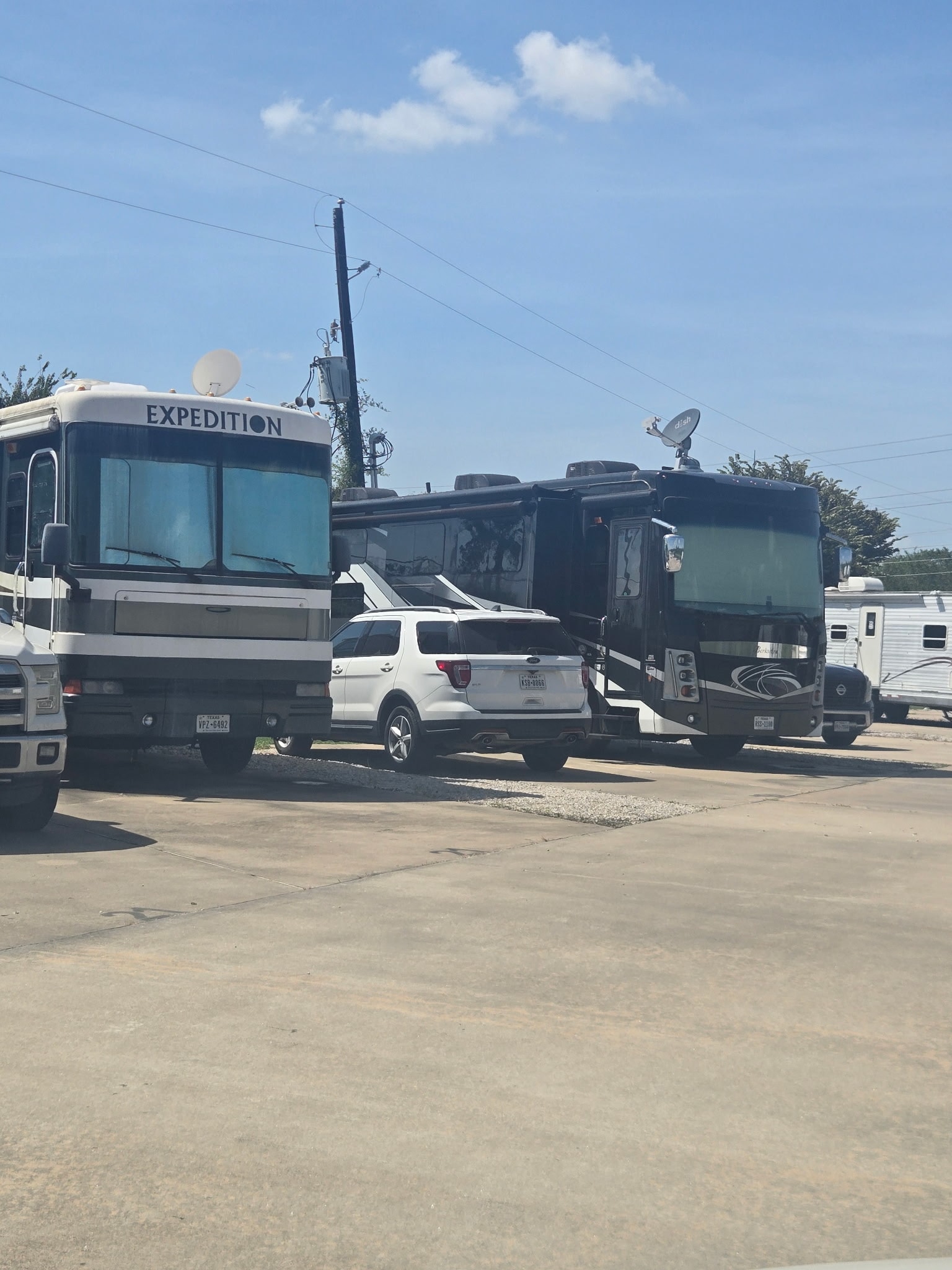 Row of RVs parked at sites with paved pads